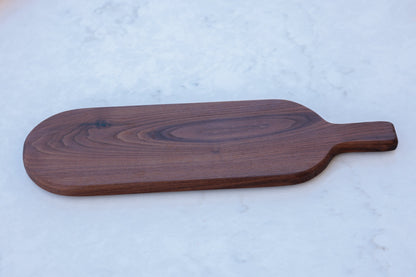 Walnut Cheese/Bread/Serving Board: Timeless & versatile, handcrafted with care. Choose straight or curved handle. Approx. 6"x18"x3/4". Exudes elegance & functionality.