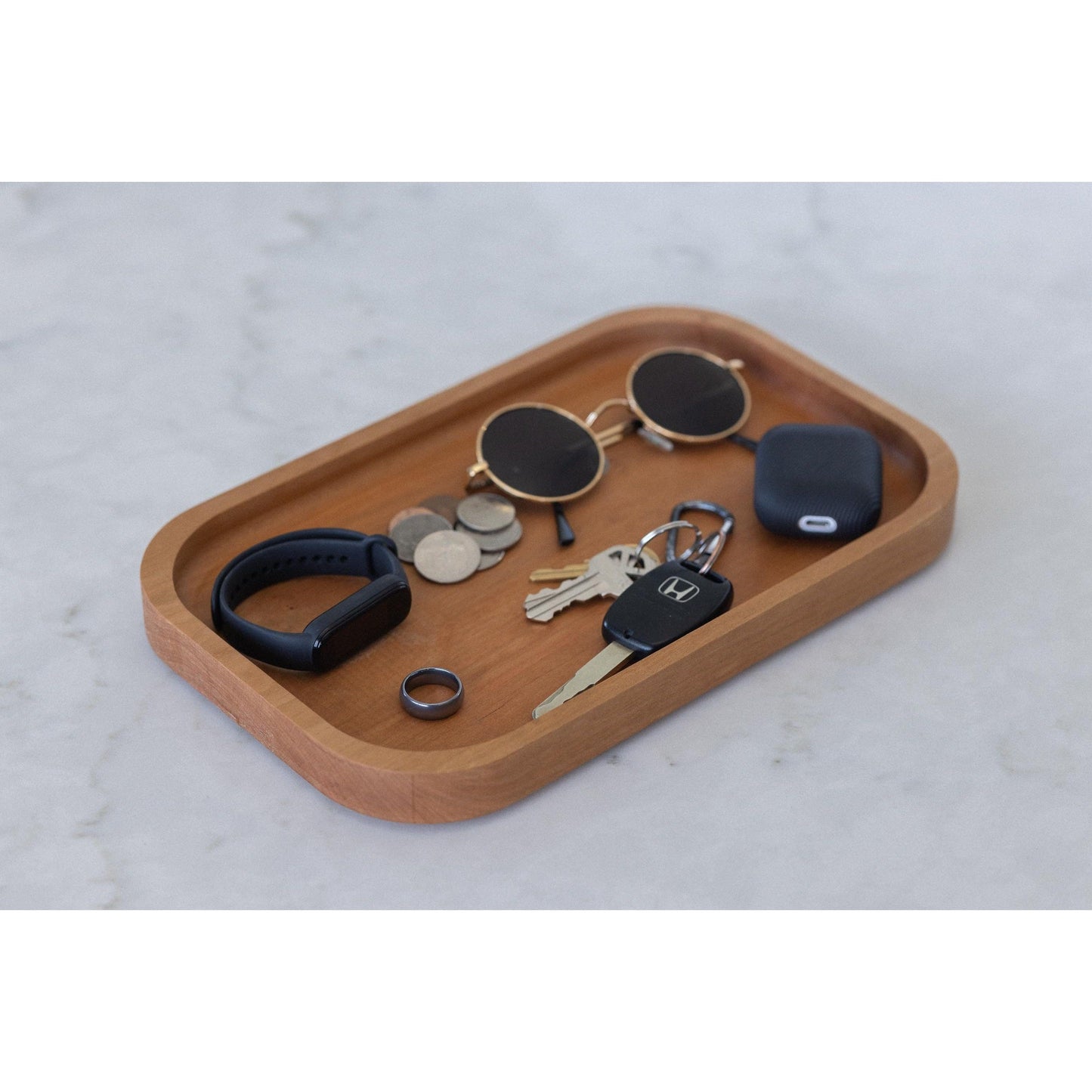 Surprise your husband or boyfriend with our hardwood valet tray, a cherry catch-all that organizes their desk. This 7"x11"x3/4" masterpiece is a practical and stylish gift, keeping their essentials organized in style at the workspace.