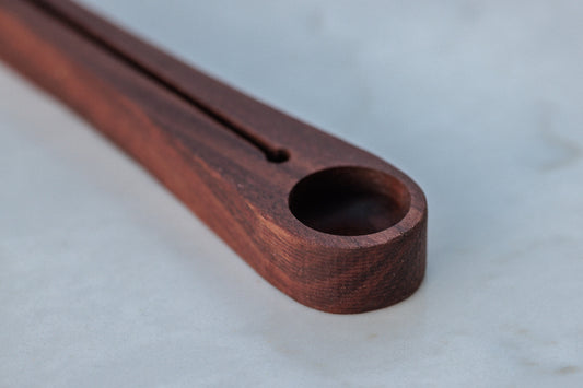 Walnut coffee scoop and bag sealer. This versatile tool allows you to measure the perfect amount of coffee and securely seal the bag for freshness. Crafted from walnut, it adds a touch of elegance to your coffee routine.