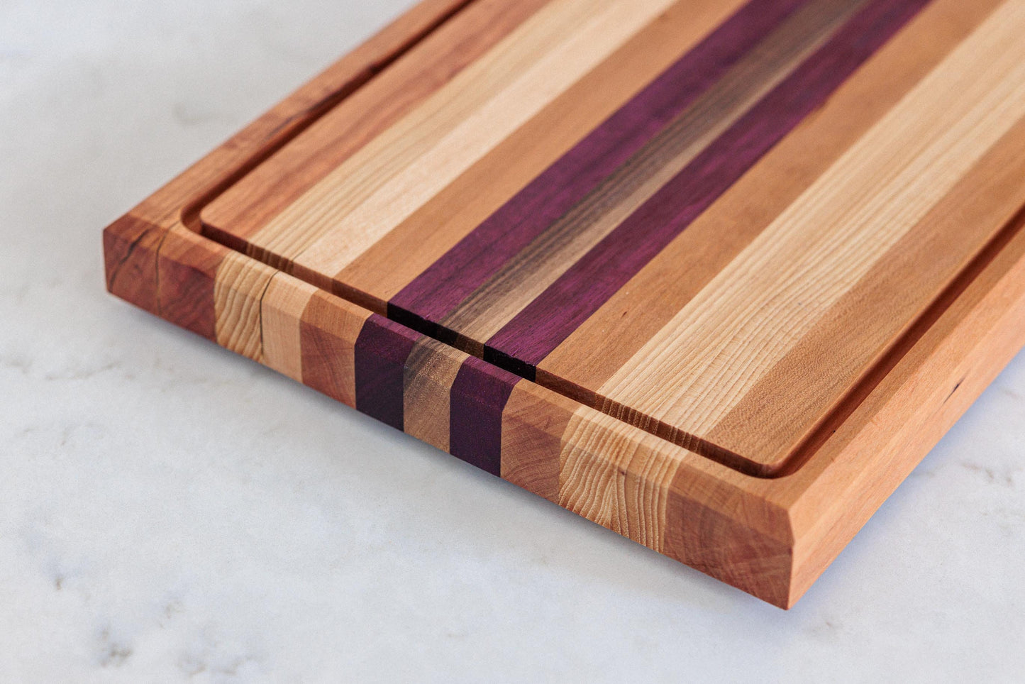 Large Hardwood cutting board with juice groove! Walnut, purple heart, hickory, hard maple, and cherry. Approx 17"x10.5"x1.5"