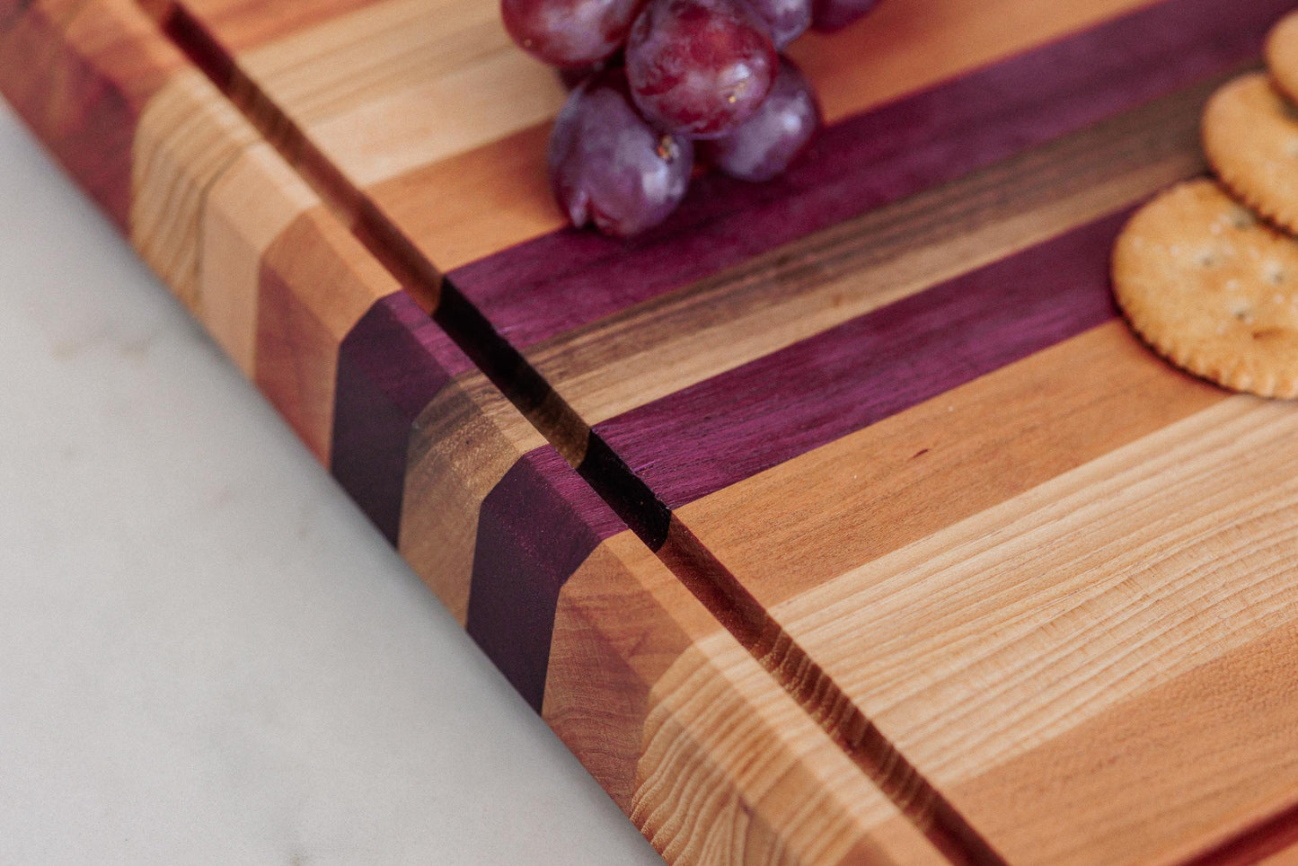 Large Hardwood cutting board with juice groove! Walnut, purple heart, hickory, hard maple, and cherry. Approx 17"x10.5"x1.5"