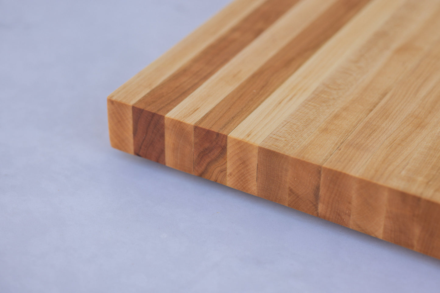 Experience the allure of our large hardwood cutting board. Expertly crafted from hard maple and hickory, this exquisite gift measures approximately 17"x10.5"x1.5". Combining beauty and functionality, it's the perfect present for culinary adventurers.